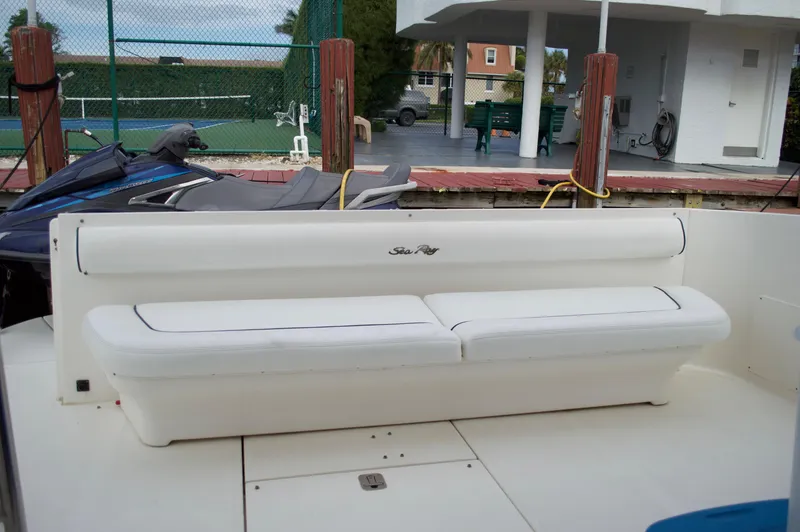 Slide: The Image of 2005 Sea Ray 550 Sedan Bridge boat with white cushioned seating. - 10