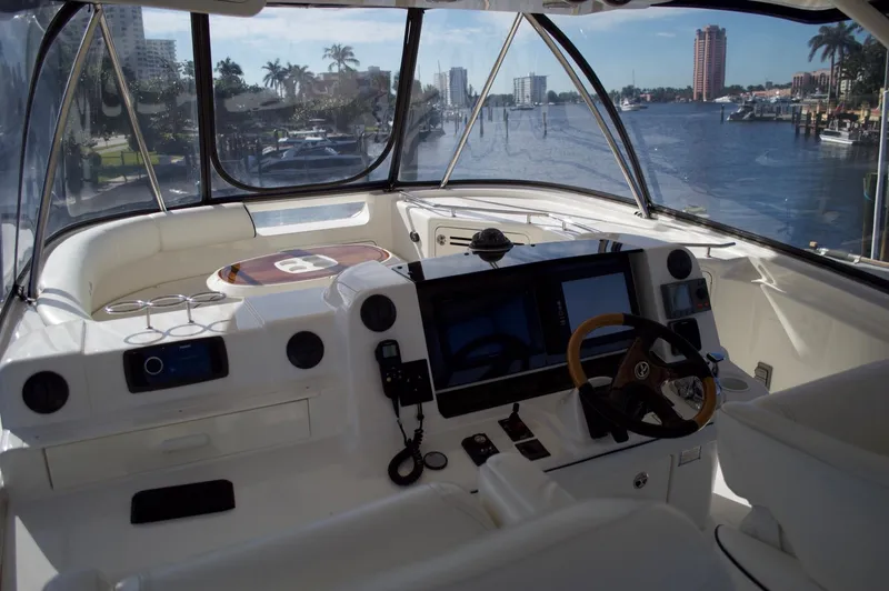Slide: The Image of 2005 Sea Ray 550 Sedan Bridge helm with waterfront view. - 14