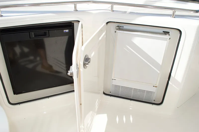 Slide: The Image of Built-in refrigerator and storage compartment on 2005 Sea Ray 550 Sedan Bridge yacht. - 15