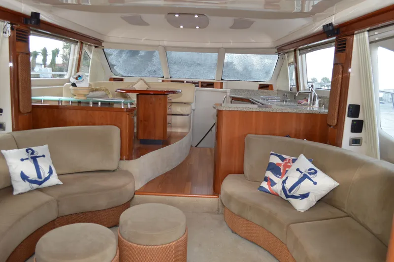 Slide: The Image of Luxurious interior of 2005 Sea Ray 550 Sedan Bridge yacht with plush seating and nautical decor. - 2