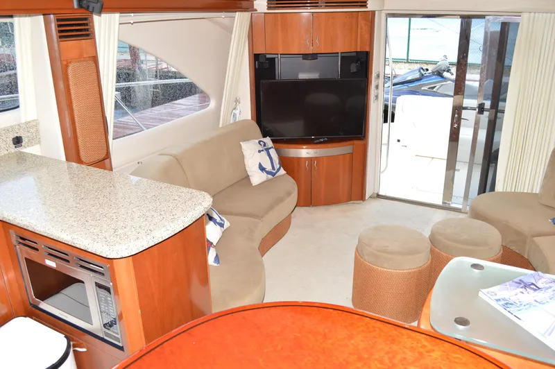 Slide: The Image of Interior of 2005 Sea Ray 550 Sedan Bridge yacht with modern furnishings and entertainment system. - 3