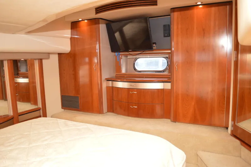 Slide: The Image of Luxurious bedroom interior of 2005 Sea Ray 550 Sedan Bridge yacht with wood cabinetry. - 9