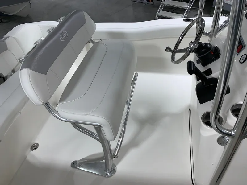 Slide: The Image of 2024 Key West 203 FS boat interior with steering wheel and seating. - 10
