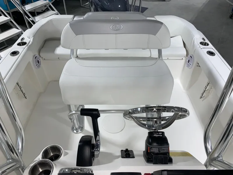 Slide: The Image of 2024 Key West 203 FS boat interior with steering wheel and seating. - 11