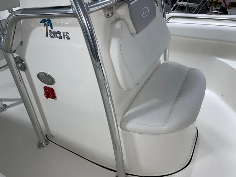 Slide: The Image of 2024 Key West 203 FS boat interior with white seating and chrome details. - 13