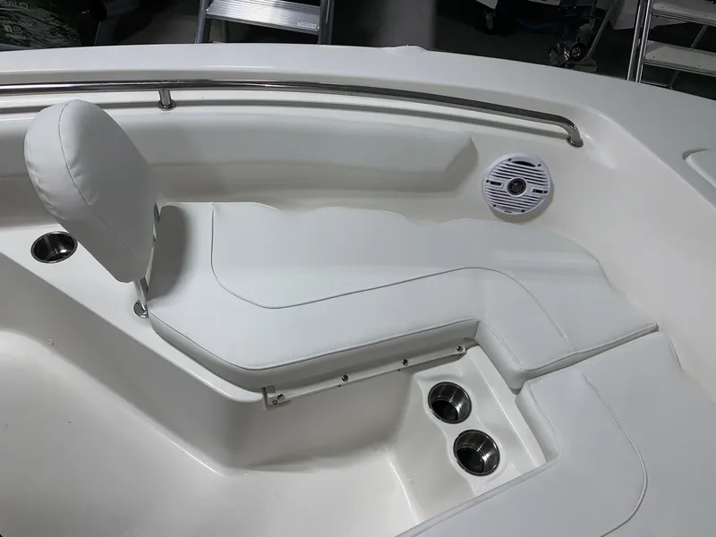 Slide: The Image of 2024 Key West 203 FS boat interior with white cushioned seating and cup holders. - 14