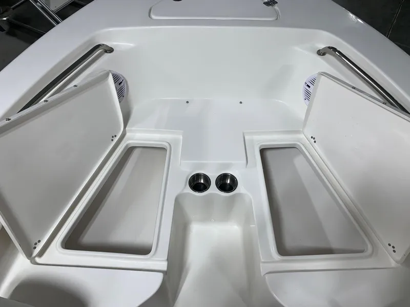 Slide: The Image of 2024 Key West 203 FS boat with open storage compartments and cup holders. - 15
