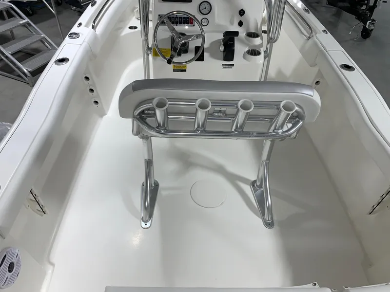 Slide: The Image of 2024 Key West 203 FS boat interior with steering console and rod holders. - 5