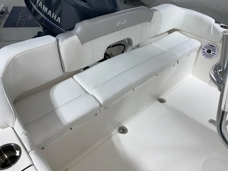 Slide: The Image of 2024 Key West 203 FS boat with white cushioned seating and Yamaha engine. - 6