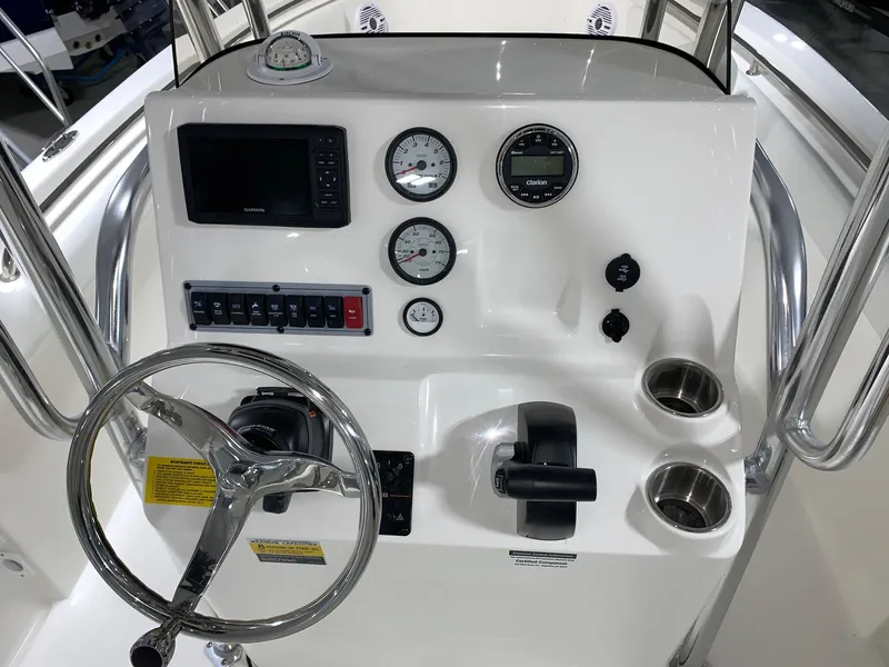 Slide: The Image of 2024 Key West 203 FS boat console with steering wheel, gauges, and controls. - 8