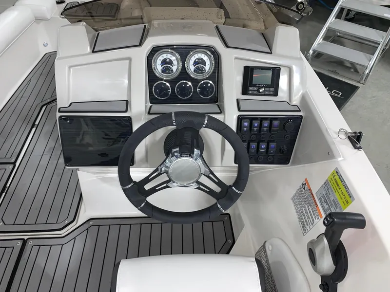 Slide: The Image of 2024 Starcraft SVX 211 boat dashboard with steering wheel and control panel. - 12