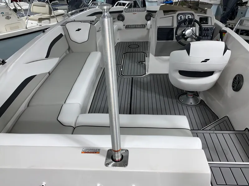 Slide: The Image of 2024 Starcraft SVX 211 boat interior with seating and steering console. - 3