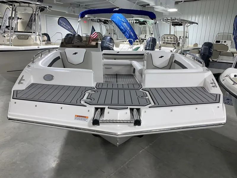 Slide: The Image of 2024 Starcraft SVX 211 boat in showroom, rear view with seating and deck. - 5
