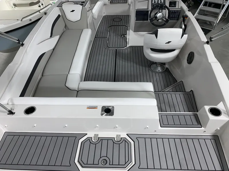 Slide: The Image of 2024 Starcraft SVX 211 boat interior with gray seating and flooring. - 8