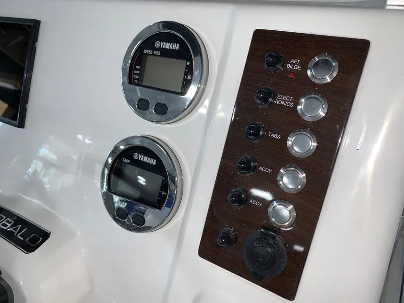 Slide: The Image of Control panel of 2024 Robalo R202 Explorer boat with Yamaha gauges and switches. - 16