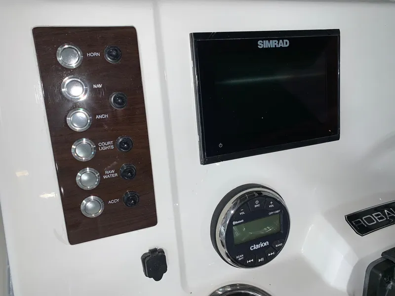 Slide: The Image of Control panel of 2024 Robalo R202 Explorer boat with Simrad display and Clarion audio system. - 17