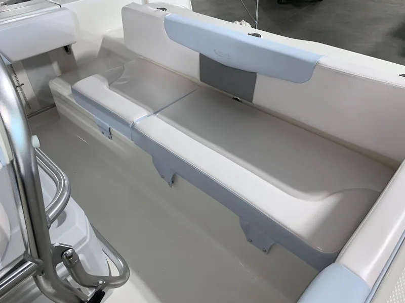 Slide: The Image of 2024 Robalo R202 Explorer boat interior seating area with white and light blue cushions. - 21