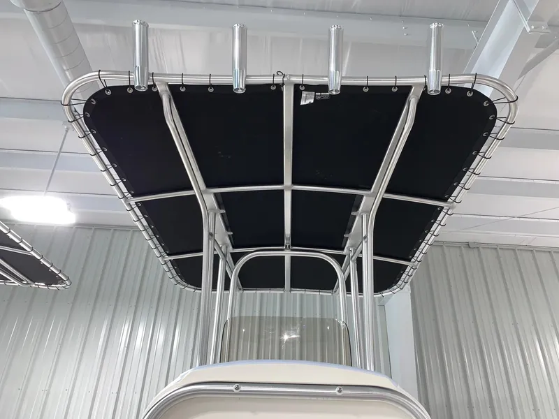 Slide: The Image of 2024 Robalo R202 Explorer boat T-top with rod holders in a showroom. - 25