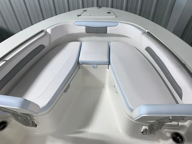 Slide: The Image of 2024 Robalo R202 Explorer boat with white cushioned seating in bow area. - 6