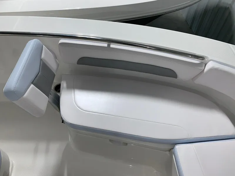 Slide: The Image of 2024 Robalo R202 Explorer boat seating area with white and gray upholstery. - 7