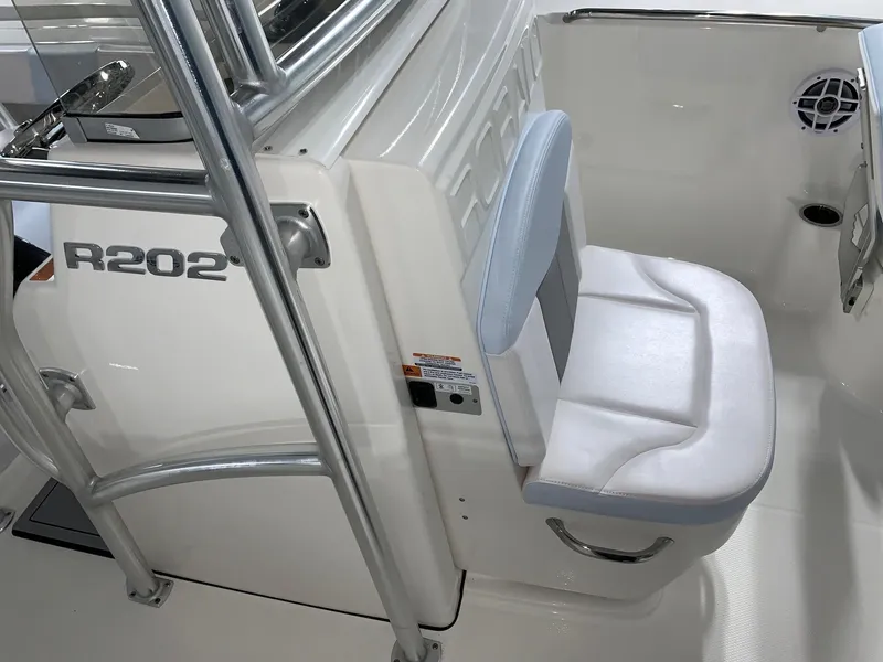 Slide: The Image of 2024 Robalo R202 Explorer boat interior with white cushioned seat. - 11