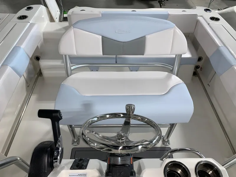 Slide: The Image of 2024 Robalo R202 Explorer boat interior with steering wheel and seating. - 13