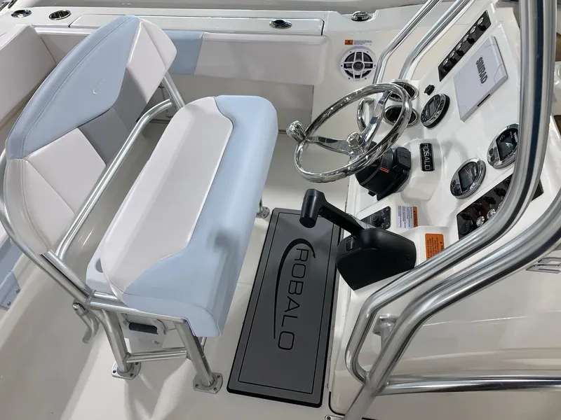 Slide: The Image of 2024 Robalo R202 Explorer boat helm with steering wheel and controls. - 14
