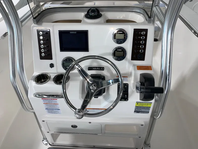 Slide: The Image of 2024 Robalo R202 Explorer boat console with steering wheel and navigation controls. - 15