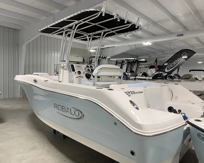 Slide: The Image of 2024 Robalo R202 Explorer boat in showroom. - 2