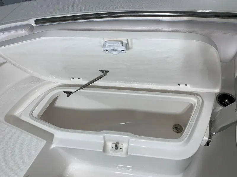 Slide: The Image of 2024 Robalo R202 Explorer storage compartment with open lid. - 9