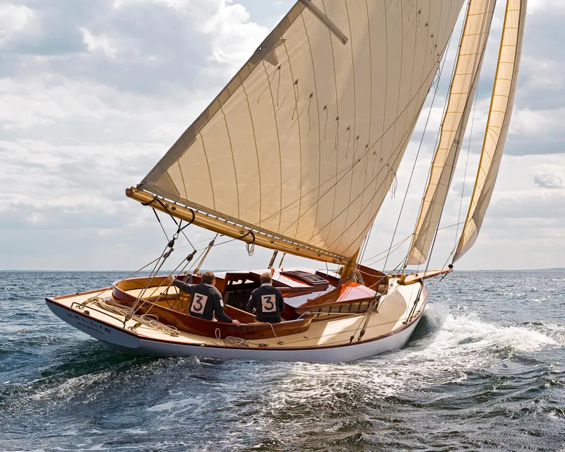 The Image of 1902 Herreshoff Gaff Cutter sailing on open sea under cloudy skies. - 0