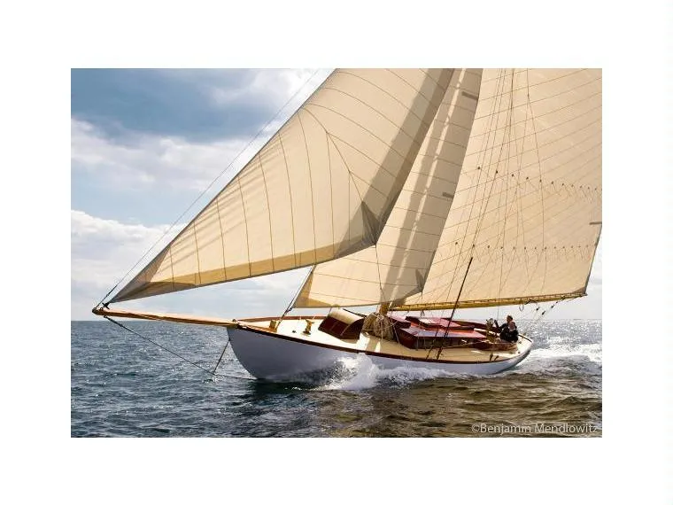 Slide: The Image of 1902 Herreshoff Gaff Cutter sailing on open water under clear skies. - 1