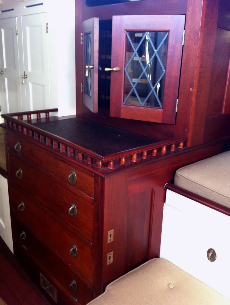 Slide: The Image of Interior of 1902 Herreshoff Gaff Cutter with wooden cabinetry and drawers. - 22