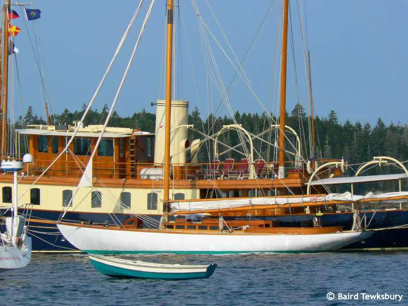 Slide: The Image of A 1902 Herreshoff Gaff Cutter sailboat moored near a classic wooden yacht. - 4