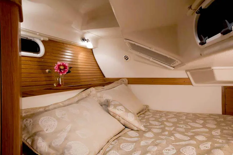 Slide: The Image of Cozy cabin interior of 2025 Catalina 356 yacht with floral decor and wooden accents. - 11