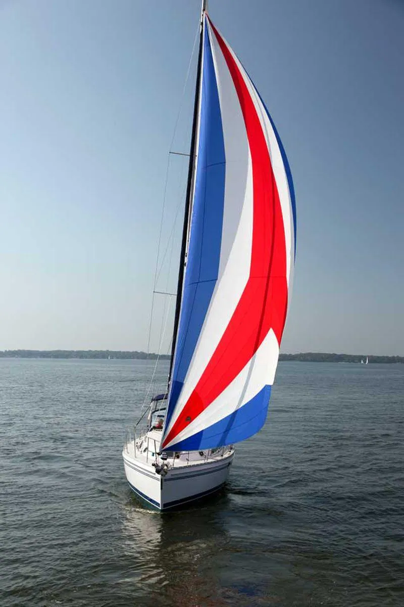 Slide: The Image of Sailboat Catalina 356 (2025) with colorful spinnaker on calm water. - 4