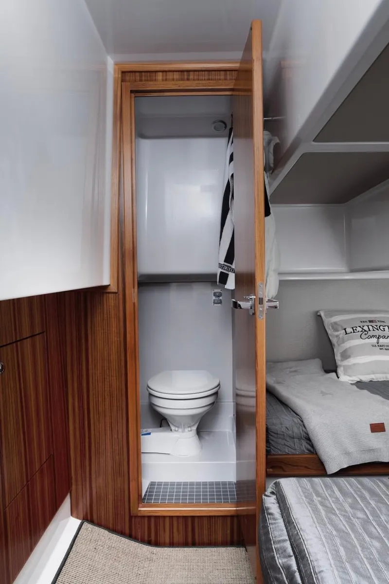 Slide: The Image of Interior of 2025 Sargo 33 boat featuring compact bathroom and cozy sleeping area. - 12