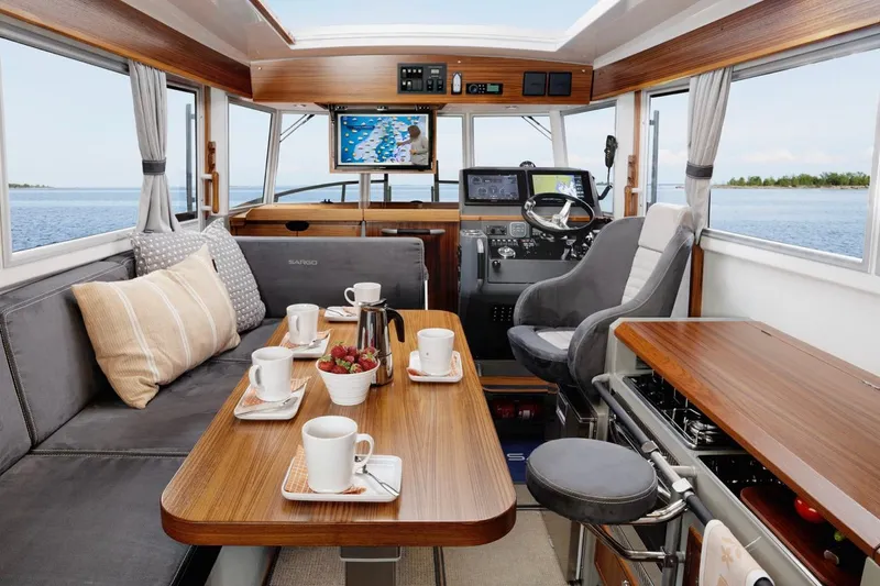 Slide: The Image of Luxurious interior of 2025 Sargo 33 boat with dining setup and navigation equipment. - 14