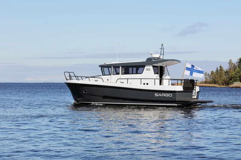 Slide: The Image of 2025 Sargo 33 boat cruising on a calm sea with Finnish flag. - 5