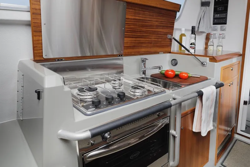 Slide: The Image of Modern kitchen in 2025 Sargo 33 boat with stove, sink, and tomatoes. - 9