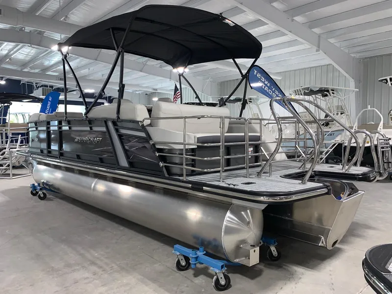 Slide: The Image of 2024 Starcraft SLS 3 Q DH pontoon boat in showroom. - 1