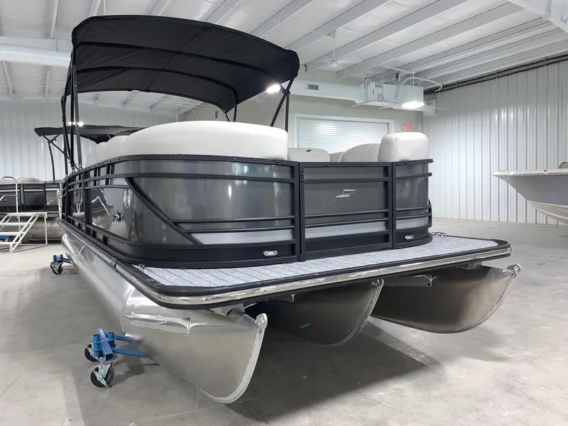 Slide: The Image of 2024 Starcraft SLS 3 Q DH pontoon boat in a showroom. - 2