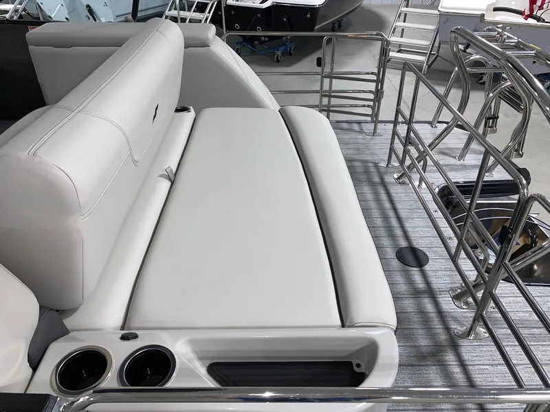 Slide: The Image of 2024 Starcraft SLS 3 Q DH boat interior with white cushioned seating and cup holders. - 7