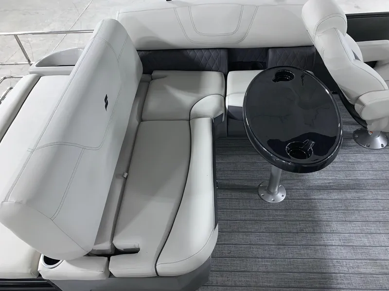Slide: The Image of 2024 Starcraft SLS 3 Q DH boat interior with plush seating and a sleek black table. - 8