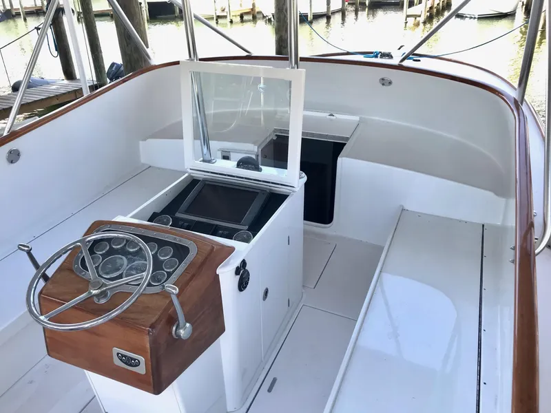 Slide: The Image of 1993 Gamefisherman 34 Express boat interior with steering wheel and control panel. - 4