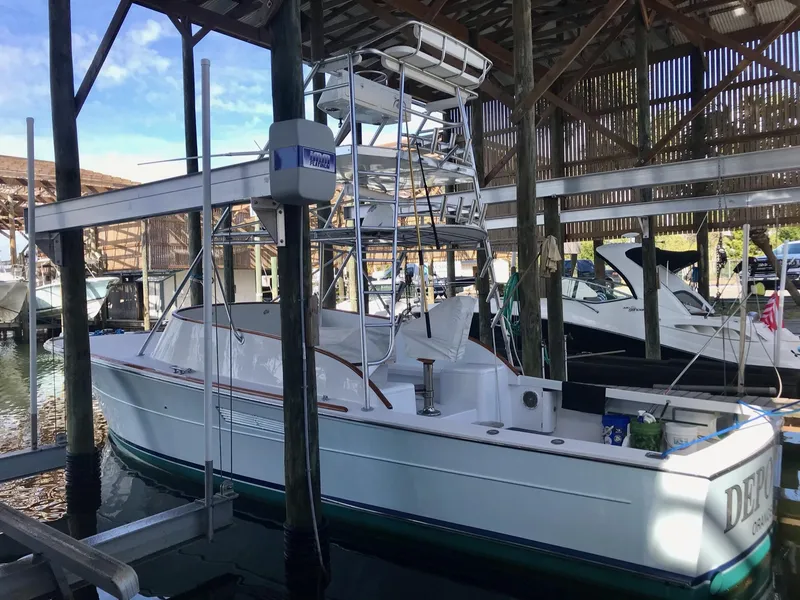 Slide: The Image of 1993 Gamefisherman 34 Express boat docked in a marina. - 5