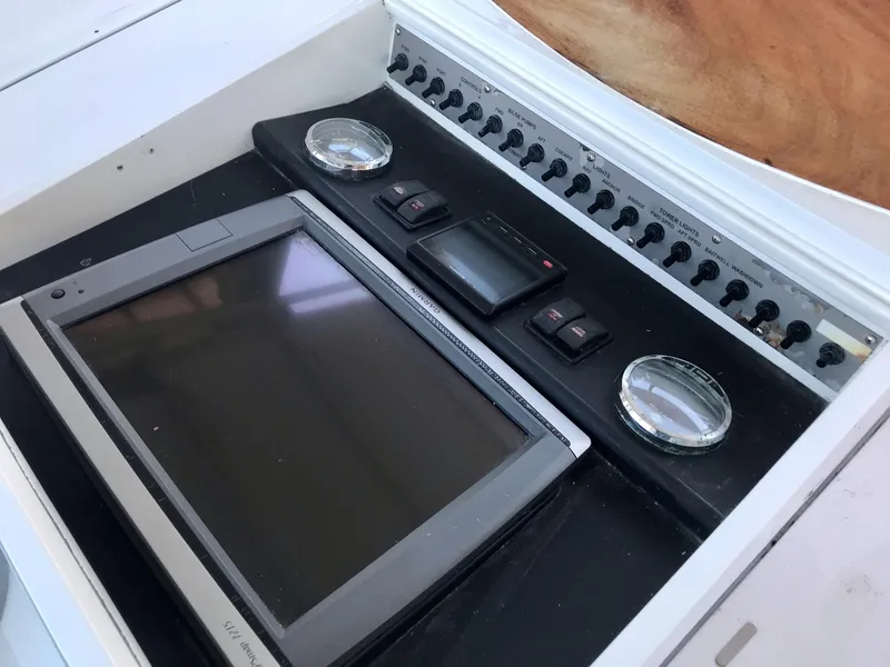 Slide: The Image of 1993 Gamefisherman 34 Express boat control panel with gauges and touchscreen display. - 6