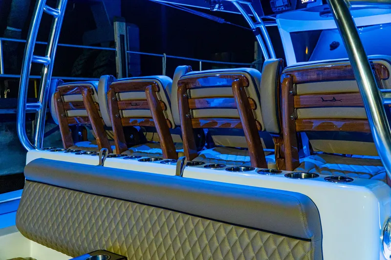 Slide: The Image of Valhalla Boatworks V-46 2025 model interior seating with blue ambient lighting. - 12