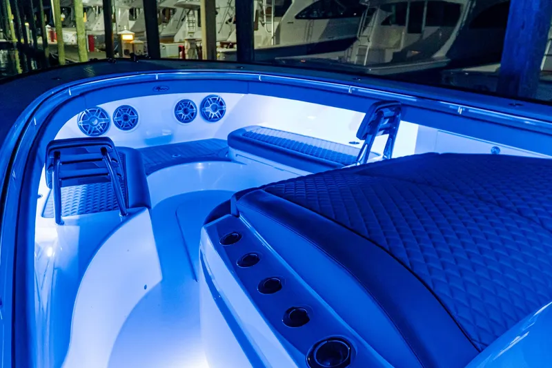 Slide: The Image of 2025 Valhalla Boatworks V-46 interior with blue LED lighting and luxurious seating. - 13