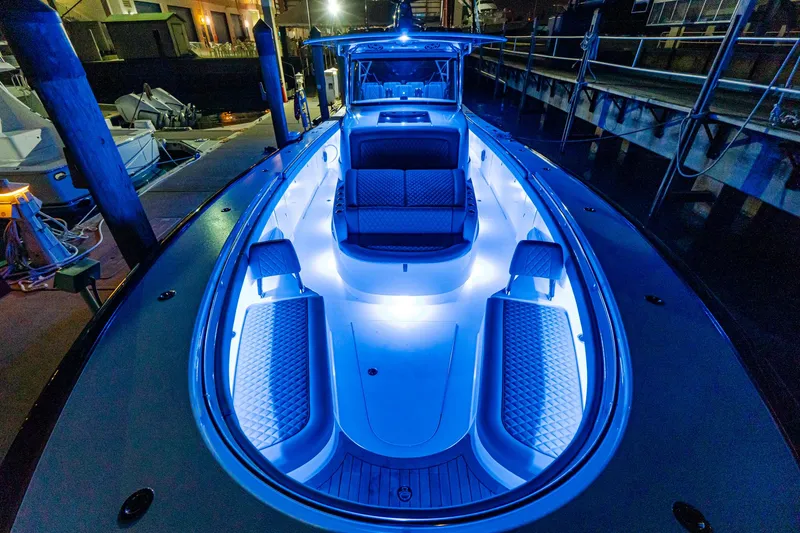 Slide: The Image of 2025 Valhalla Boatworks V-46 with blue LED deck lighting at night. - 15